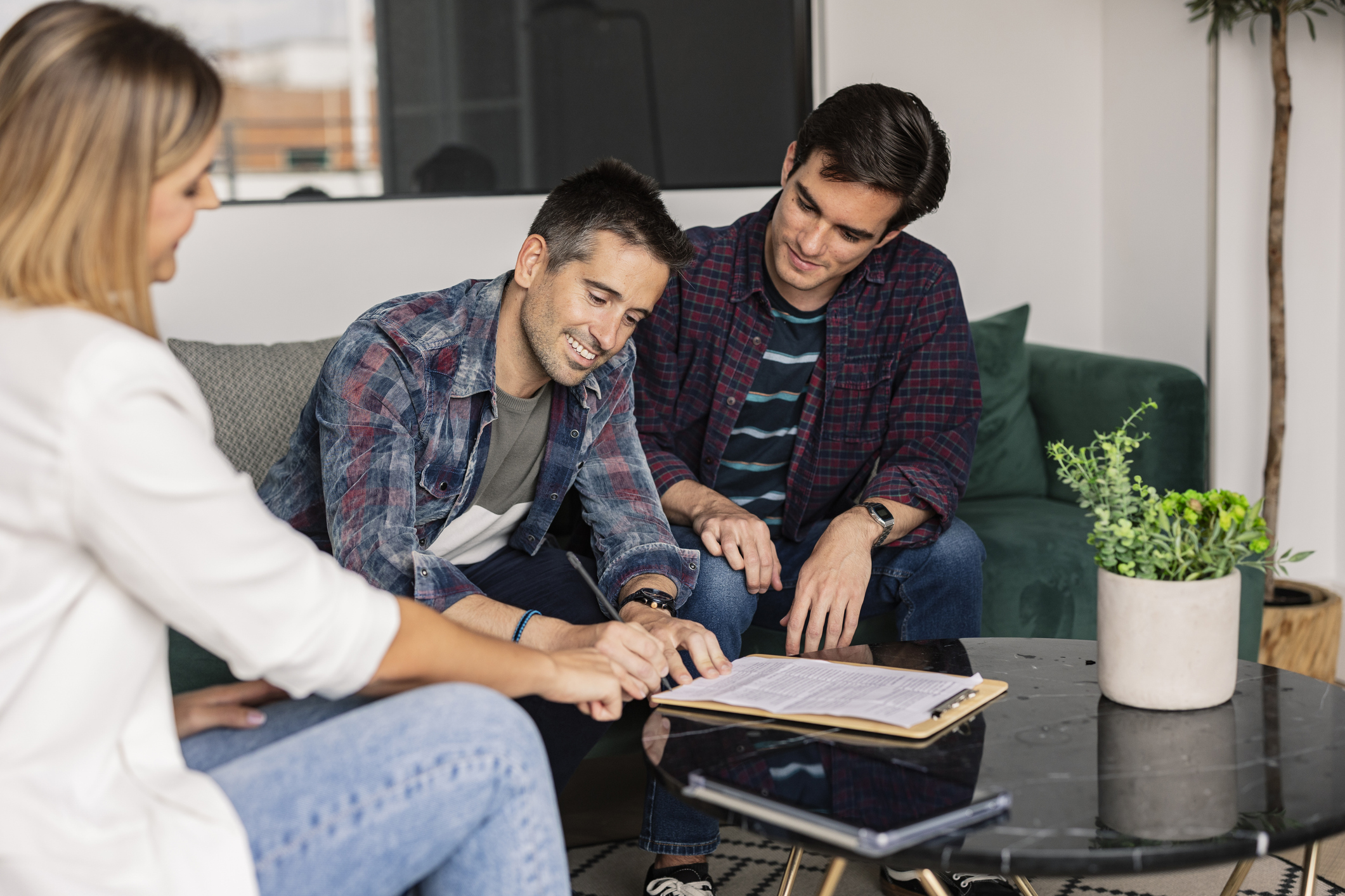 gay couple in real estate signing the purchase of their new house Erben
