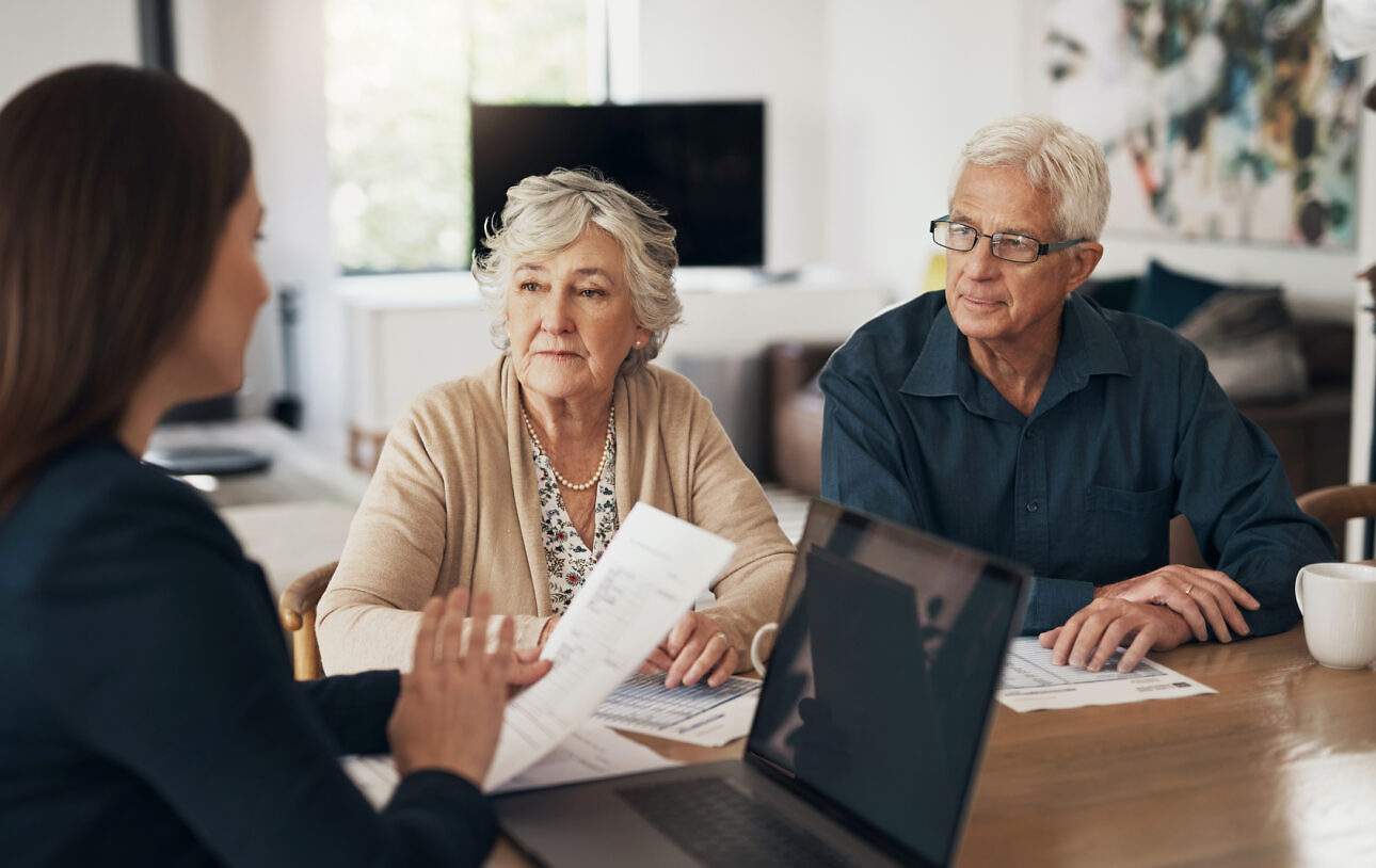 Documents, senior couple and meeting with a financial advisor, lawyer or woman consulting on a contract, loan or deal. Investment, papers and people with a mortgage, debt or saving in retirement Sale and lease back